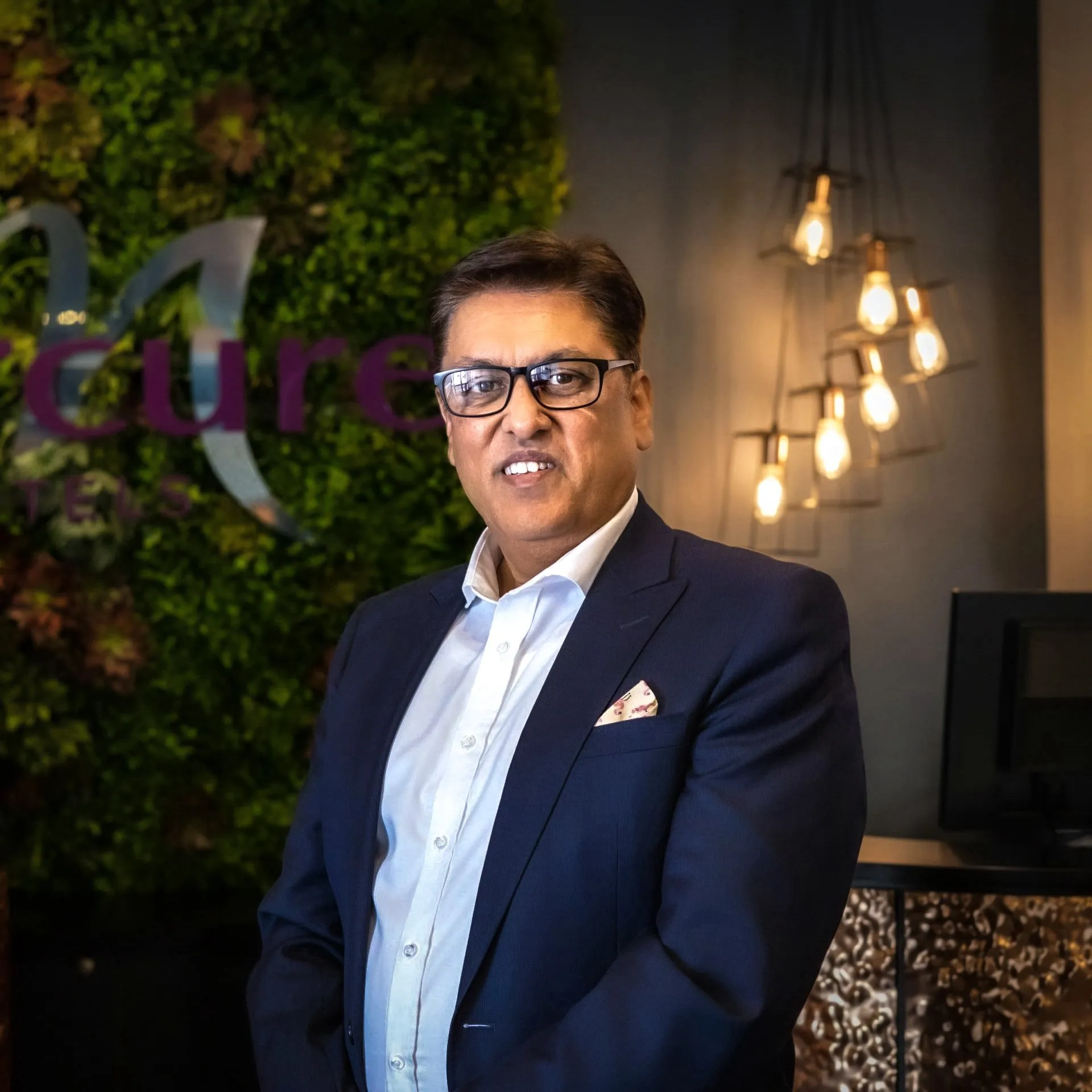 Sanjay S. Mahajan, Founder and Principal, photographed in a hotel lobby